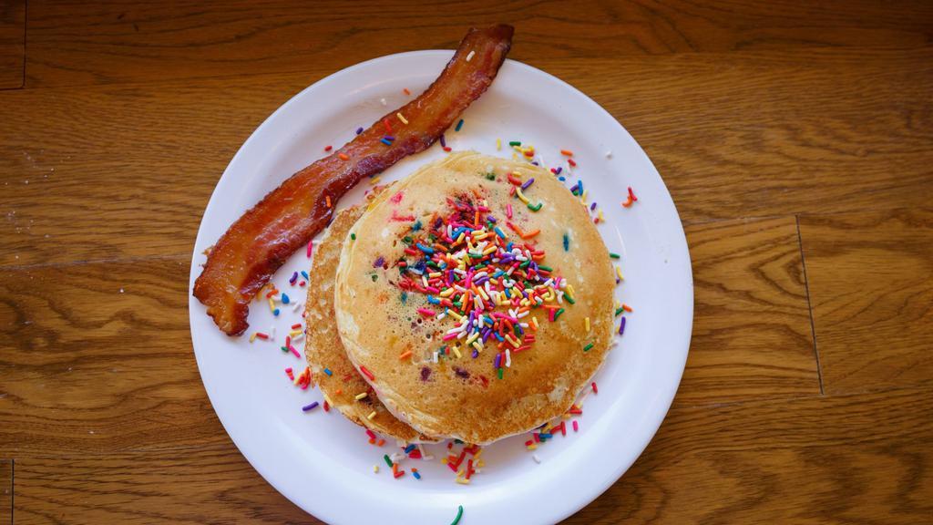 Funfetti Shortstack · two buttermilk sprinkle pancakes, one maple bacon, seasonal fruit cup