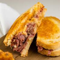 Malone'S Reuben · Wigley's corned beef stacked then topped with sauerkraut and Swiss cheese on grilled rye wit...