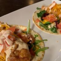 Dublin Fish Tacos · Beer battered cod fried with cajun spice served on two tortillas with spring mix, tomatoes, ...