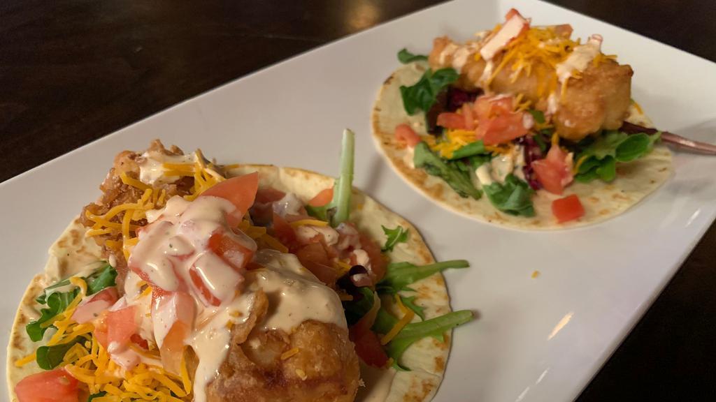 Dublin Fish Tacos · Beer battered cod fried with cajun spice served on two tortillas with spring mix, tomatoes, cheddar cheese and topped off with our dublin sauce.