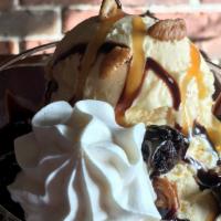 Bear Claw Sundae · Vanilla ice cream drizzled in caramel & hot fudge topped with brownie bites and pecans with ...
