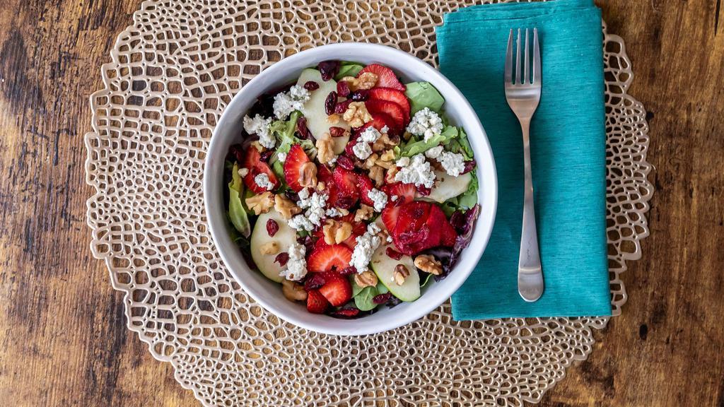 Strawberry, Apple Walnut Salad · Mixed greens, granny smith apple, strawberries, dried cranberries, roasted walnuts, blue cheese crumbles, topped with a house-made pomegranate dressing.