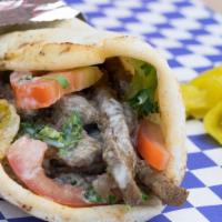 Beef Shawarma Sandwich · Seasoned hand cut beef with chopped parsley, tomatoes, onions, sliced sweet peppers, and pic...