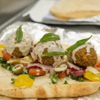 Falafel Sandwich · Mix of fava and garbanzo beans packed into little balls and deep fried to a crisp with tomat...