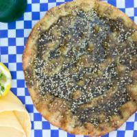 Zaatar Flat Bread · Dough topped with za'atar (thyme, oregano, sesame seeds and olive oil).