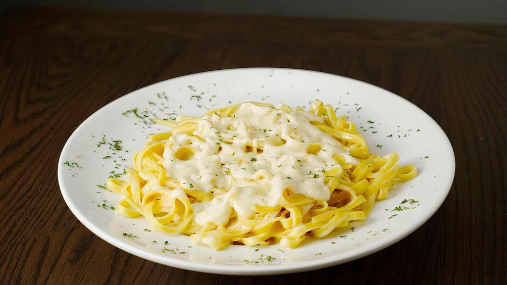 Fettuccine Alfredo Pasta · Fettuccine noodles and Alfredo sauce. Served with garlic bread and grated cheese.