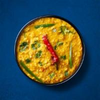 Divine Yellow Lentils  · Yellow lentils, slow-cooked to perfection and tempered with cumin, garlic, and chilies. Serv...