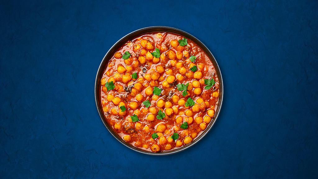 Chickpea Supreme · Chickpeas, slow-cooked till soft in an onion and tomato curry with Indian whole spices. Served with a side of aromatic white rice.