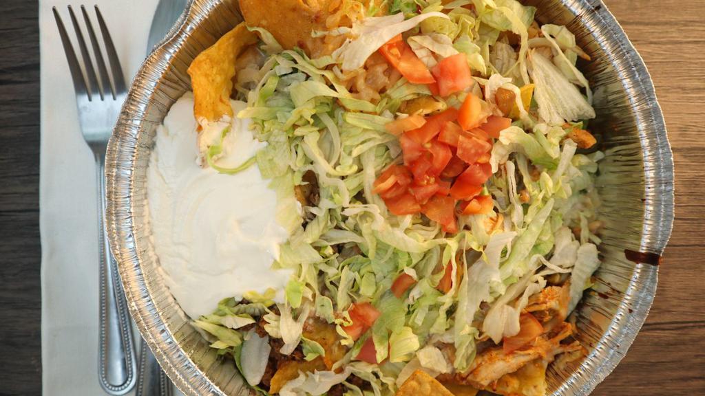 #71. Nachos Supreme · Toasted corn tortilla chips covered with a delicious blend of melted cheese, beef, chicken and beans all covered with shredded lettuce, tomato, guacamole, pico de gallo and sour cream.