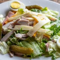 Maurice Salad · Crisp iceberg and romaine lettuce, turkey, ham, hard-boiled egg, American, swiss, and sweet ...