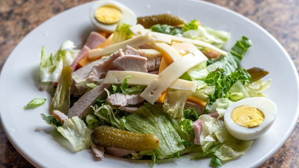 Maurice Salad · Crisp iceberg and romaine lettuce, turkey, ham, hard-boiled egg, American, swiss, and sweet gherkins served with Maurice dressing.