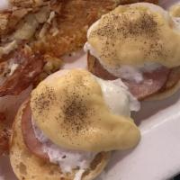 Eggs Benedict · Two halves of an English muffin topped with Canadian bacon, poached eggs and hollandaise sau...