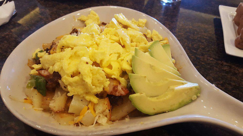 Huevos Rancheros · Cubed potatoes, chorizo, cheddar jack cheese, green peppers, tomatoes, onions and avocado topped with eggs any style.