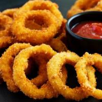 Onion Rings · Perfectly battered, fried onion rings and served with our house steak sauce.
