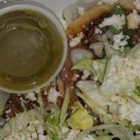Sope · Corn sope deep fried topped with beans your choice of meat garnished with lettuce, onions, t...