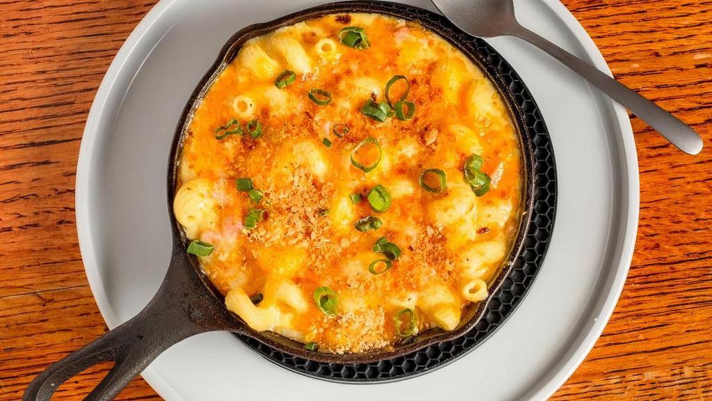 Mac N Cheese Dinner · Cavatappi pasta tossed with ham and smoked cheese cream sauce, topped with toasted bread crumbs, scallions, Monterey jack and cheddar cheeses. Add broccoli, add blackened chicken for an additional charge.