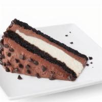 Chocolate Mousse Cake · Layers of dense chocolate cake, white chocolate mousse, and milk chocolate mousse, sprinkled...