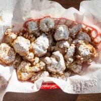 Chicken & Waffle Bites · Bite sized pieces of chicken, dipped in waffle batter and deep fried, then topped with powde...