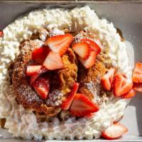 Cookie Butter Chicken & Waffles · Waffle topped with cookie butter spread, three chicken strips, strawberries, and whipped cre...