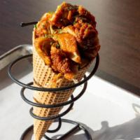 Chicken In A Cone · Waffle cone stuffed with chicken and drizzled with your choice of sauce.