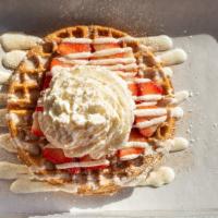 Cinnamon Roll Waffle · Waffle topped with strawberries, vanilla ice cream or whipped cream, and powdered sugar.