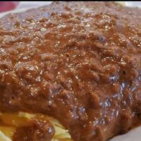Mexican Omelette · A Mexican delight with ground beef, green peppers and onions, topped with our famous chili a...