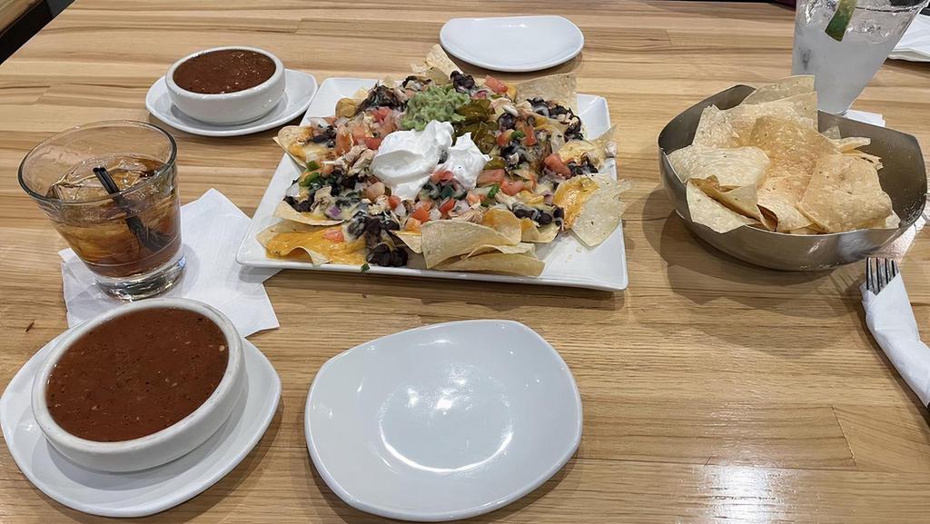 Nachos · Choice of ground beef, chicken or steak w/ black beans, queso, shredded cheese, jalapeños, pico soup cream and guacamole.