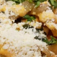 Cotija Fries · French fries fried with poblano peppers and onions smothered with chipotle aioli, cilantro a...
