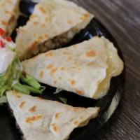 Quesadilla Fajitas · Big flour tortilla filled with grilled steak or chicken, grilled onions, bell peppers and ch...