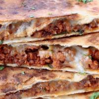 Chorizo Quesadilla · A big flour tortilla filled with mildly spicy chorizo and cheese. Served with sour cream.