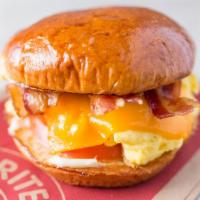 Applewood Smoked Bacon Breakfast Sandwich · Toasted brioche bun, mayo, scrambled eggs, Tillamook Cheddar.
