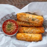 Hand Rolled Cheese Sticks · Mozzarella and cheddar hand rolled in wonton skins, deep fried and dusted with parmesan.
