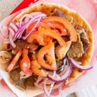 Gyro · Gyros a classic Greek sandwich, with meat cut from a spit, wrapped in a pita, onions , tomat...