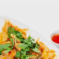 Kiew Tod · Deep fired wonton stuffed with marinated ground chicken served with freshly made sweet chili...