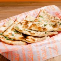 Garlic Naan  · Warm, fresh, topped with finely chopped garlic and cilantro baked to perfection from scratch...