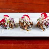 Garnachitas · Thick flattened out tortilla pan-fried, tomato sauce, shredded flank steak, sour cream, and ...