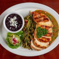 Pollo A La Parrilla · Grilled butterfly chicken breast with black beans, guacamole, arriera Mexicana salsa, and ca...