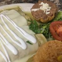 Enchiladas Suizas (4) · Tortillas in a mild sauce stuffed with your choice of chicken, beef, or sausage, topped with...