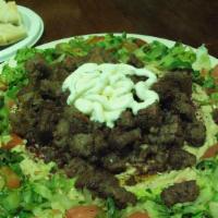 Lamb Shawarma Salad · Salad topped with lamb shawarma.