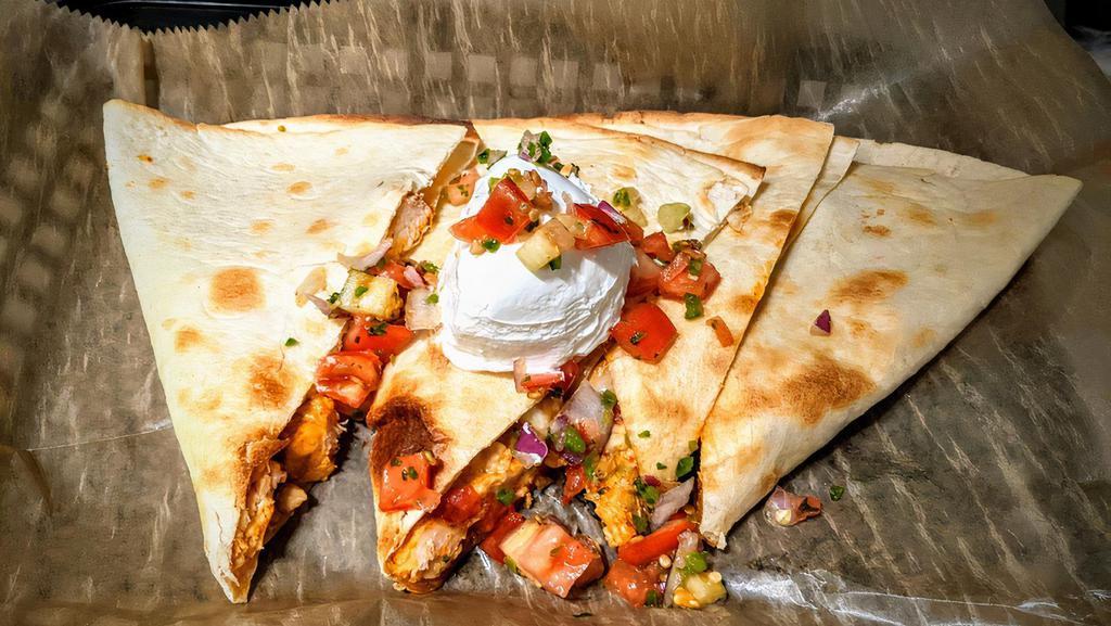 Buffalo Chicken Quesadilla · Roasted chicken with spicy buffalo sauce, fresh pico de gallo, and melted cheese in a toasted tortilla. Served with ranch.