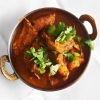 Kukhura Ko Masu (Chicken Curry) · Tender boneless pieces of chicken cooked in a light tomato curry sauce.