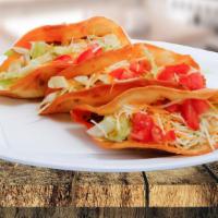 Shell Taco · Served with ground beef, lettuce, yellow cheese, and sour cream / servido con carne molida l...