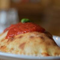 The Meatball Calzone · Marinara sauce, our house cheese blend,  and our specialty meatballs.