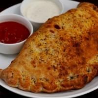 The Spicy Combo Calzone · House tomato sauce, Italian beef, spicy sausage, house blend cheese, and hot giardiniera.