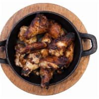 Chicken Wings · Wood fired chicken wings. Served with your choice of ranch, blue cheese, or honey sriracha f...