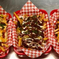 Burger Fries · Loaded fries with ground beef, grilled onions, lettuce, tomatoes, and cheese sauce.