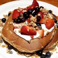 Mixed Berry Stone Ground Whole Wheat Pancakes · Topped with low-fat yogurt, granola, fresh strawberries and blueberries.