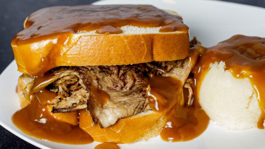 Hot Beef · Slow roasted Certified Angus Beef® between two thick slices of sourdough bread and smothered with gravy.