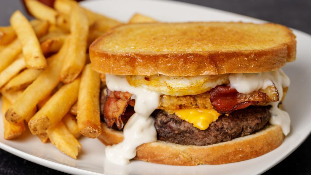 Anytime · Melted American cheese, crispy hash brown patty, country style gravy, bacon, and an egg on grilled sourdough.