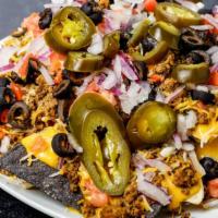 Macho Nacho · Tortilla chips topped with seasoned beef or chicken, nacho cheese, cheddar jack cheese, toma...